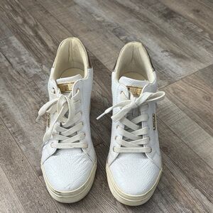 Guess women’s white and gold heeled sneakers